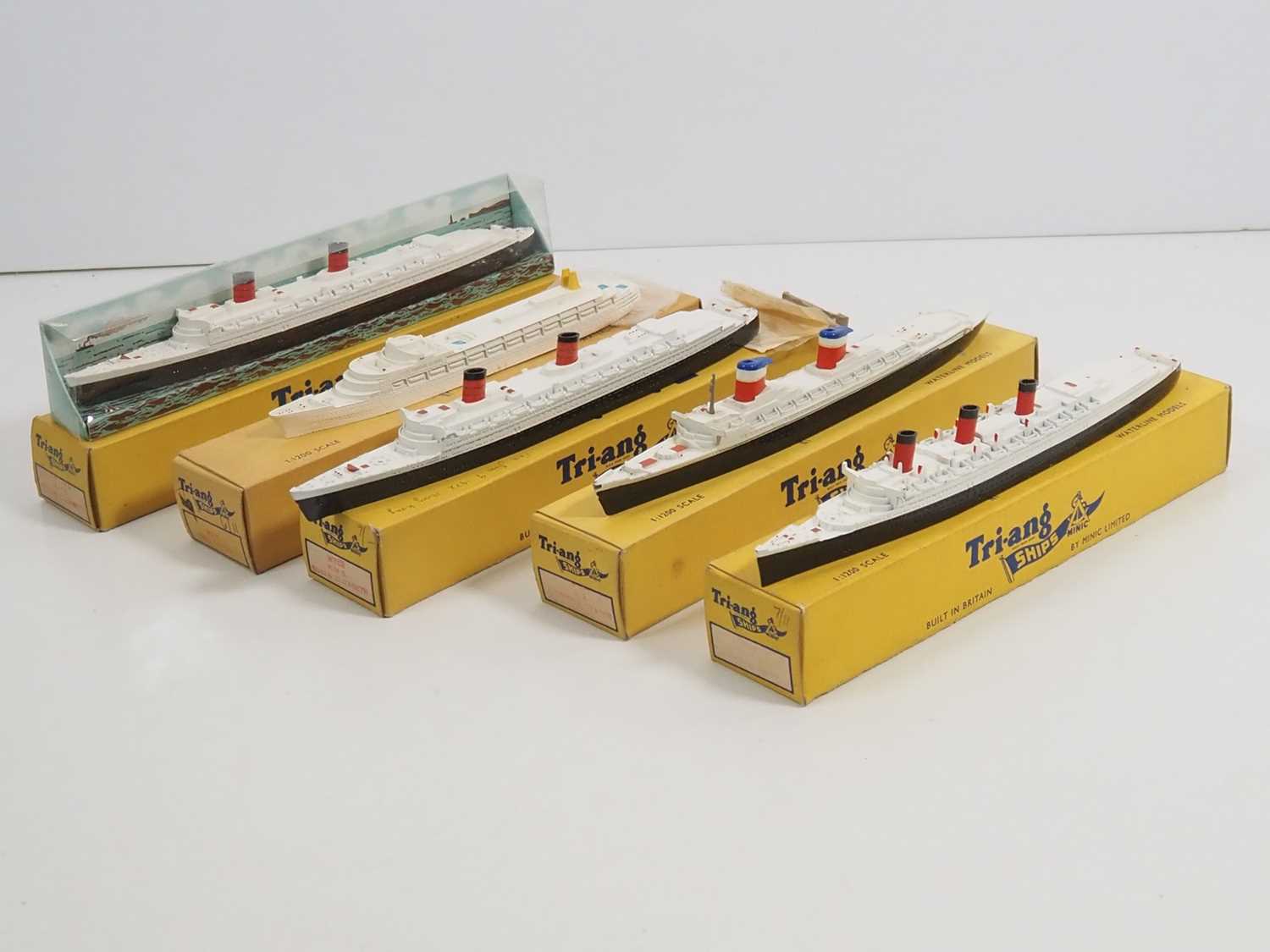 A group of vintage TRI-ANG MINIC ocean liners comprising 2x M702 RMS Queen Elizabeth (in different