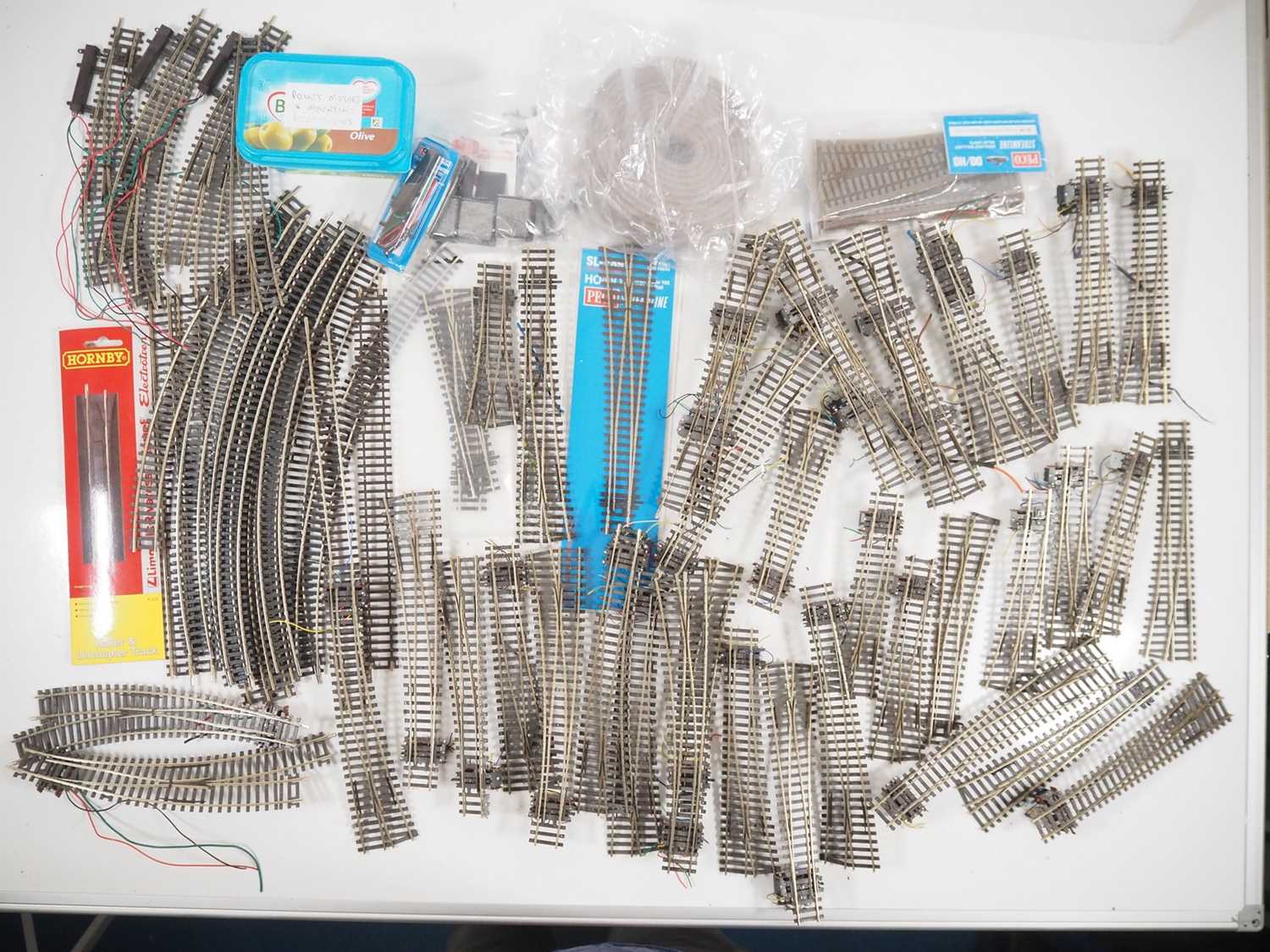 A large quantity of PECO Streamline and HORNBY OO gauge track and accessories including circa 40