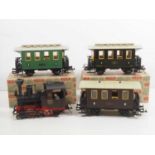 A group of LGB G gauge rolling stock comprising a steam tank loco and 3 coaches (one boxed, and