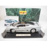 A MAISTO 1:12 scale model of a Jaguar XJ220 in silver - VG in G/VG box