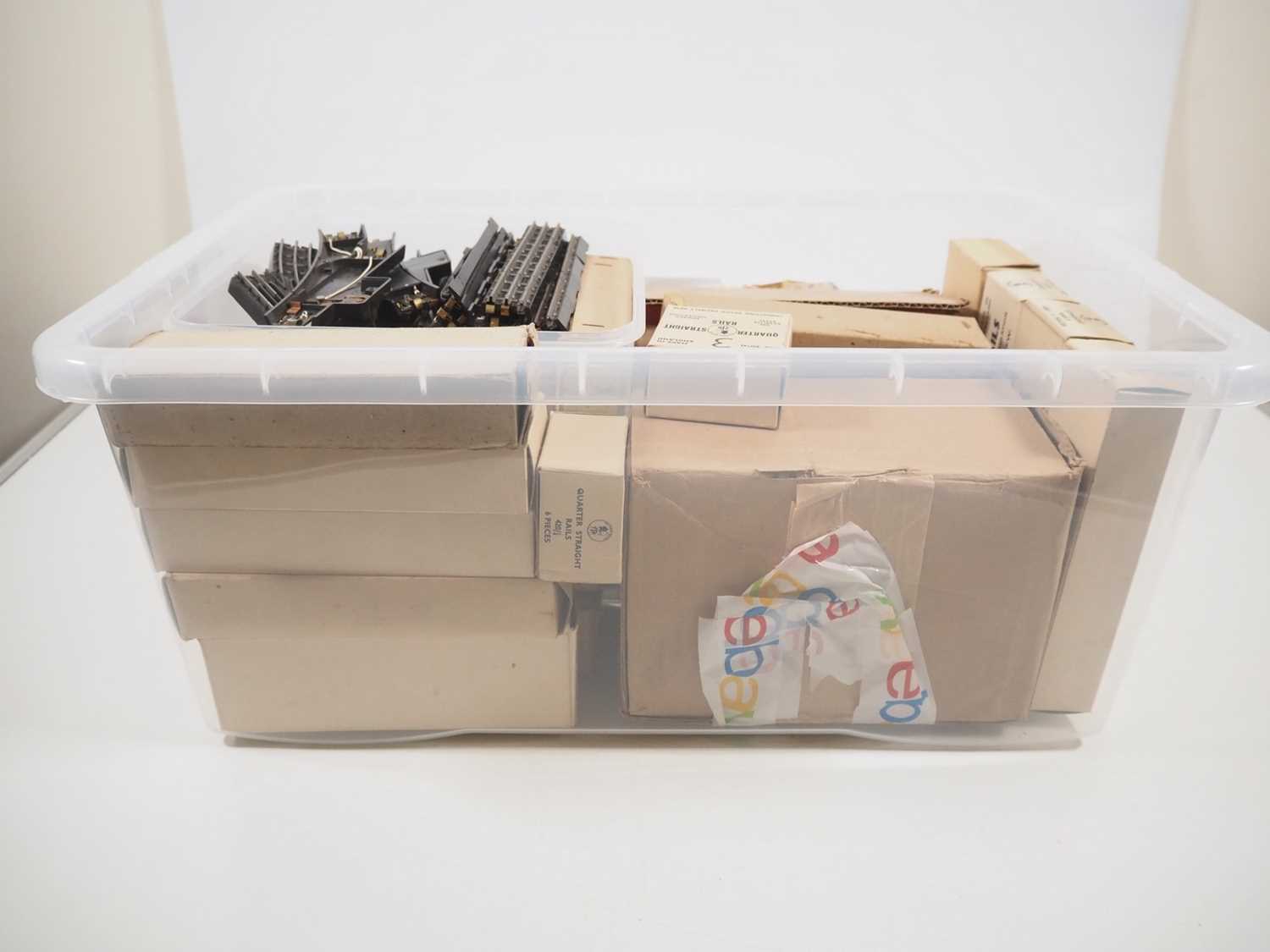 A large plastic crate filled with boxed and unboxed TRIX TWIN OO gauge 3-rail bakelite track - G - Image 2 of 2