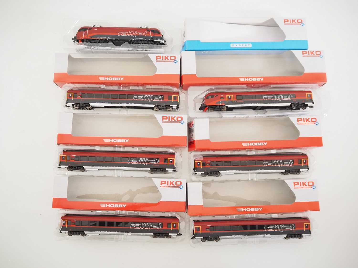 A group of PIKO HO gauge Austrian outline rolling stock comprising a Taurus electric locomotive,