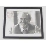 A framed and glazed candid 10" x 8" black/white photograph of Sean Connery - signed 'Best Wishes,