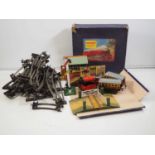 A group of HORNBY O gauge clockwork items including loco, coaches, buildings, accessories and