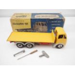 A SHACKLETON TOY Foden F.G Flatbed truck with wind up mechanism in yellow with grey mudguards /