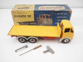 A SHACKLETON TOY Foden F.G Flatbed truck with wind up mechanism in yellow with grey mudguards /