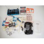 A large quantity of OO gauge spare parts and trackside accessories to include a box of bogie and