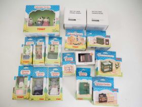 A group of TOMY SYLVANIAN FAMILIES comprising family members and accessories including an accordion,