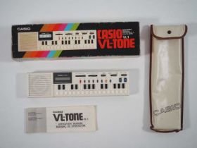 A CASIO VL-Tone VL-1 electronic keyboard - circa early 1980s in original box with original carry