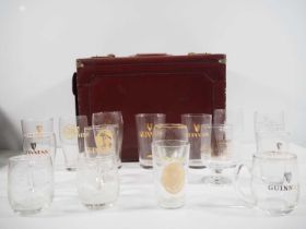 A group of 16 Guinness drinking glasses of various measurements including pints, half pints etc