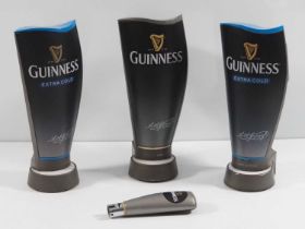 A group of 3 Guinness beer pump covers, Two of which are Extra Cold, one regular, c. 2008