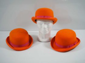 A group of three orange bowler hats by milliners Denton Hats, as worn during the London 2012