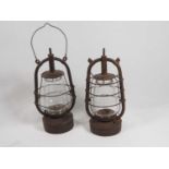 Two Early-20th century Storm Lanterns; Veritas Pax Made in England embossed with an Elephant on