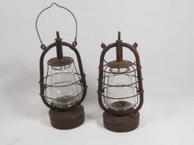 Two Early-20th century Storm Lanterns; Veritas Pax Made in England embossed with an Elephant on