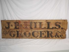 A vintage wooden shop sign reading 'J. B. Hills Grocer & Co' (2) approx 153cm x 22cm