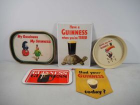 GUINNESS Advertising memorabilia: A group of four Guinness related trays, banner and advertising