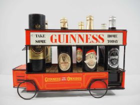 GUINNESS metal Omnibus beer cart bottle display by Acme Showcard Co Ltd (1965) with 8 mixed