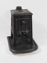 A cast iron wood burning stove of small proportions, 38cm x 27.5 x 32cm
