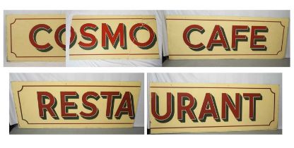 A large painted glass café sign reading 'Cosmo Café Restaurant', in several pieces: piece 1: '