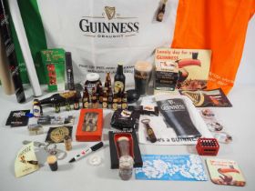 A large quantity of mixed GUINNESS collectables to include playing cards, reproduction advertising