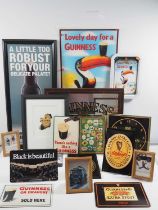 A collection of Guinness reproductions tin plate signs, a mirrored bar plaque, a lenticular