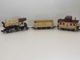 A group of unboxed ARISTOCRAFT G scale rolling stock comprising a locomotive, wagon and caboose from