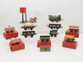 A quantity of HORNBY O gauge clockwork rolling stock and accessories - some in original boxes - F/