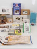 A group of O gauge buildings and accessory kits in wood plastic and resin by various manufacturers -