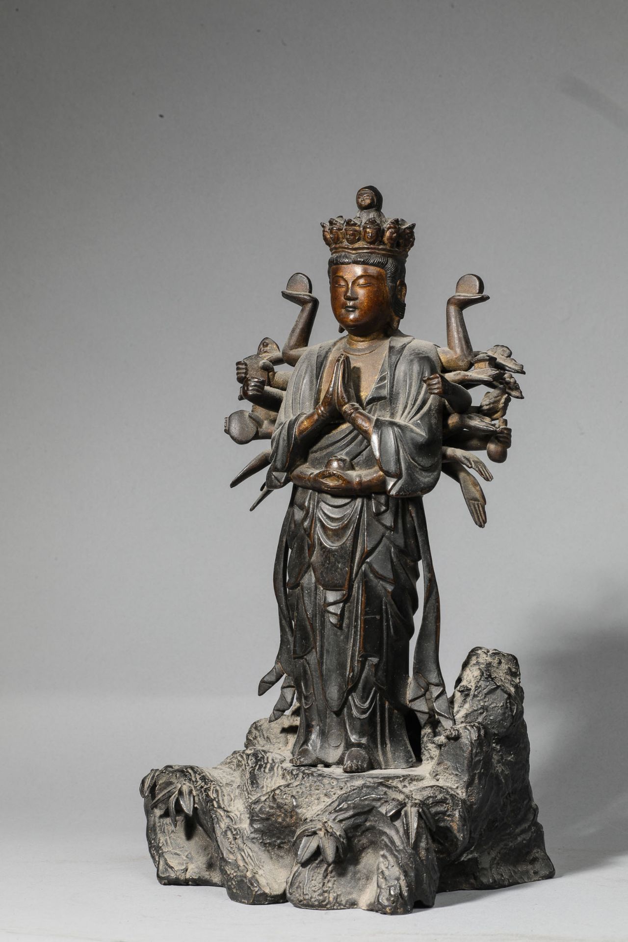 Kannon , le Boddhisattva de la compassion, debout dans une posture hiératique, sur un rocher,