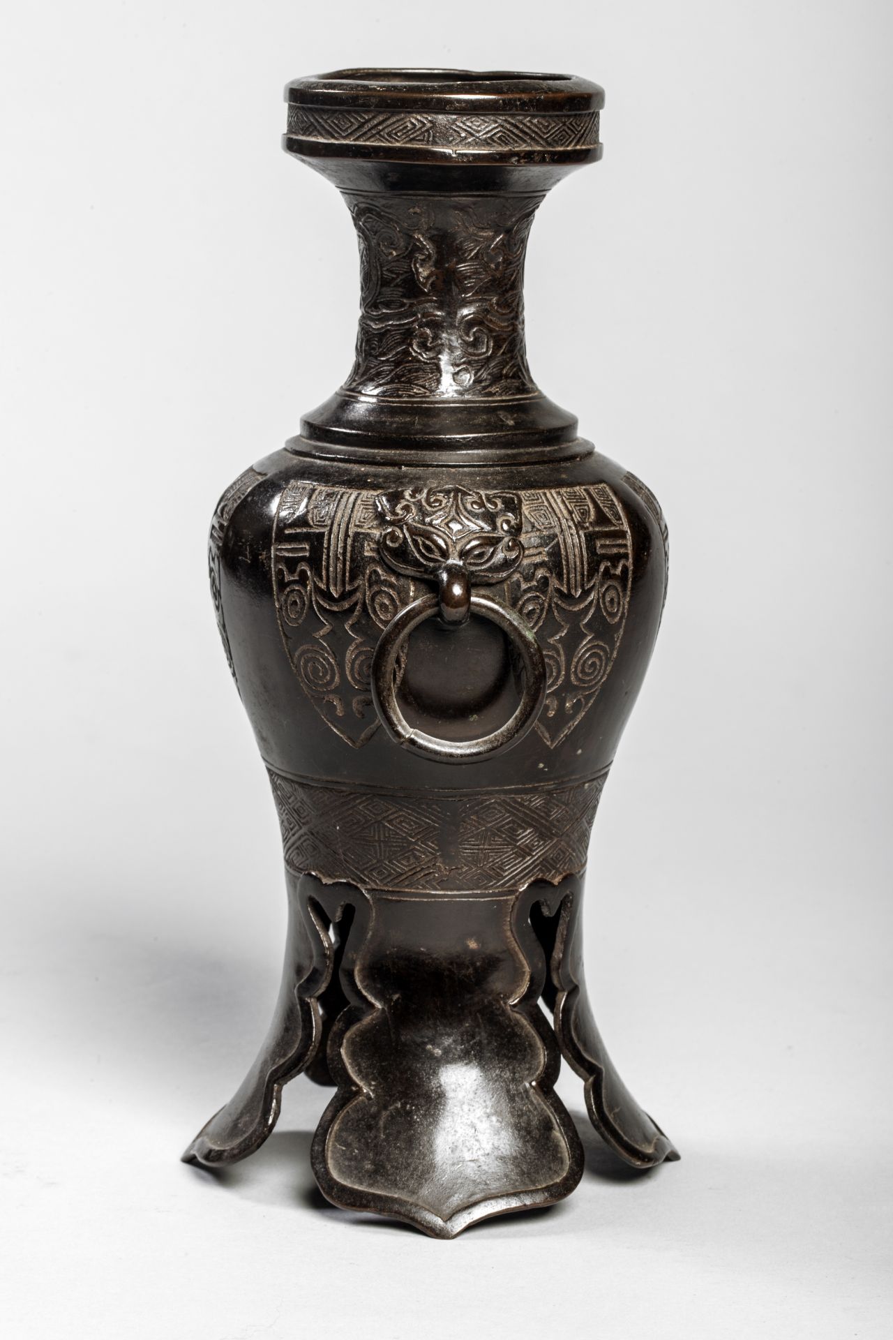 Vase balustre moulé d'un décor archaïsant sur piètement à découpe et anses de masque de Tao Tié à