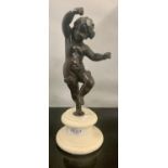 A SMALL BRONZE FIGURE OF A PUTTI OR CHERUB DANCING MOUNTED ON AN ALABASTER BASE