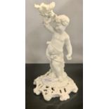 A MOORE BROTHERS BLANC DE BLANC CANDLESTICK IN THE SHAPE OF A DANCING CHERUB HOLDING A FLORAL