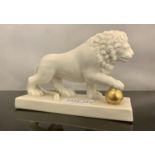 IN THE MANNER OF LUDWIGSBURG - A REGENCY LION WITH PAW ON GILDED BALL WHITE PORCELAIN