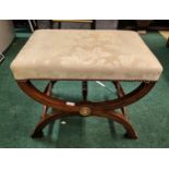 A REPRODUCTION REGENCY 'X' FRAMED FOOTSTOOL WITH DAMASK UPHOLSTERY