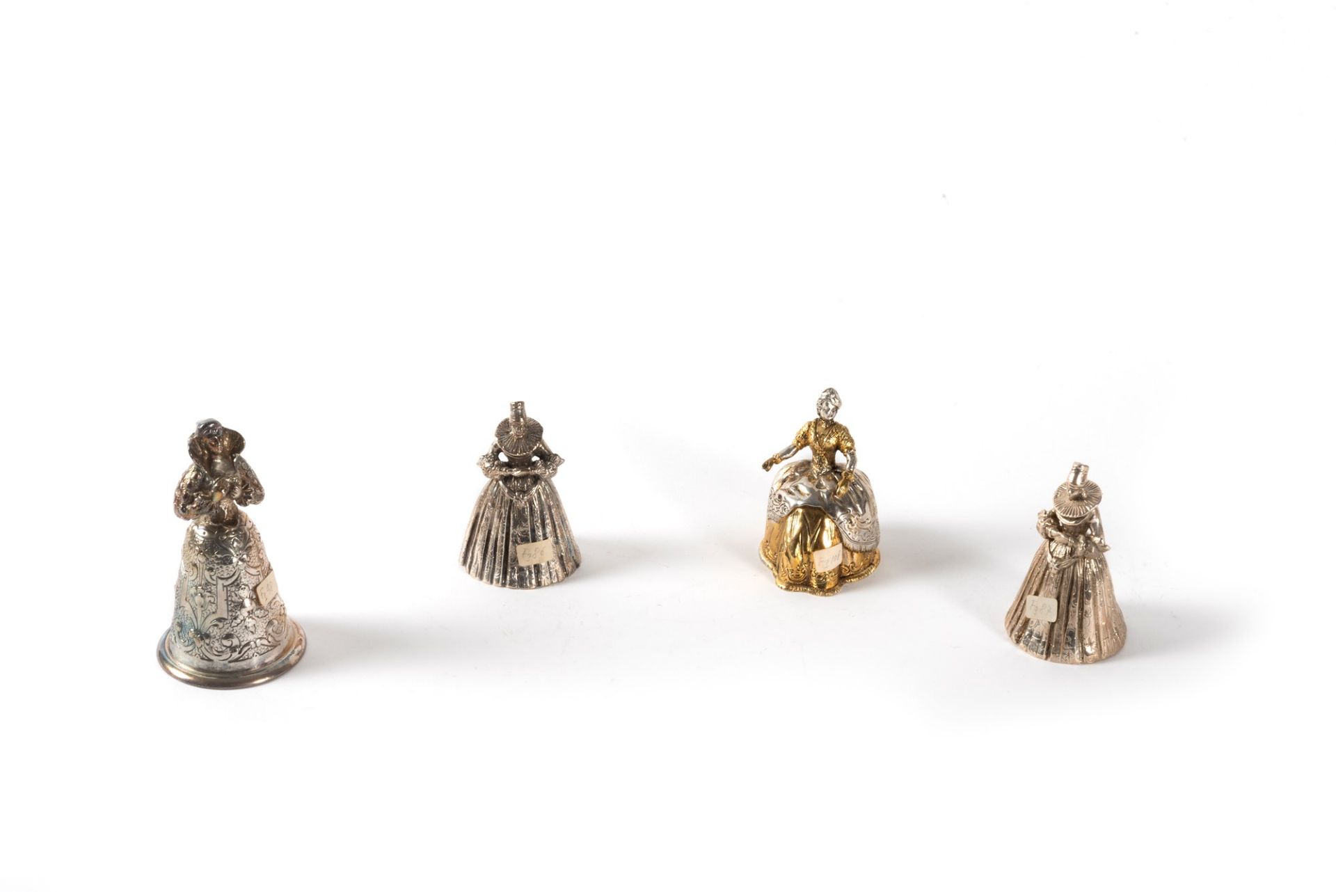 Lot consisting of four silver bells depicting female figures, 20th century