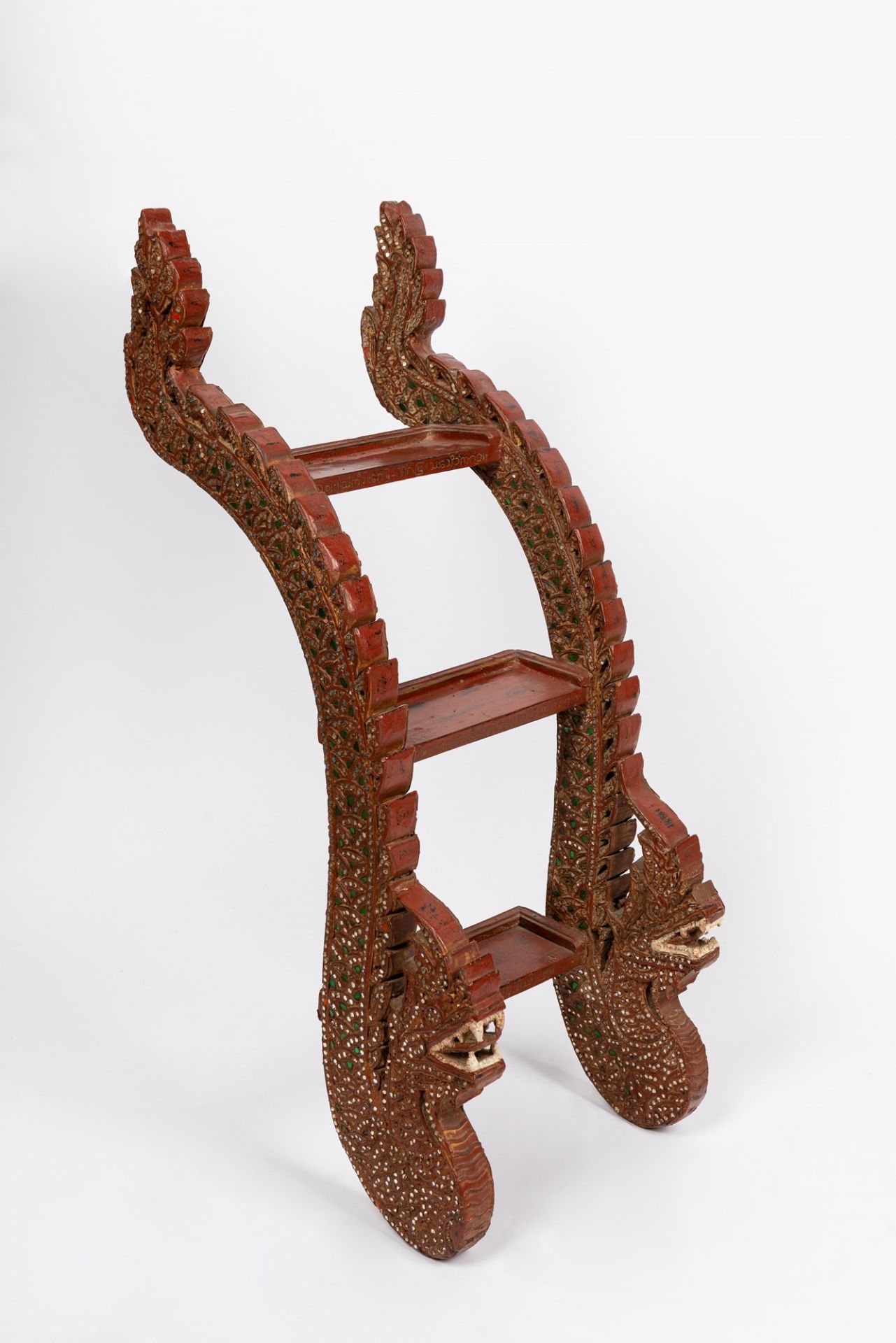 A carved wood step ladder with dragon supports. South East Asia, early 20th century