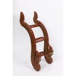 A carved wood step ladder with dragon supports. South East Asia, early 20th century