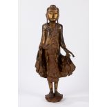 A Mandalay-Style lacquer and gilt wood figure of standing Buddha. Burma, early 20th century