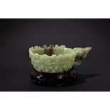 A green jade and russet carving. China, 20th c.