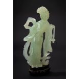A green jade carving of a lady with a fan