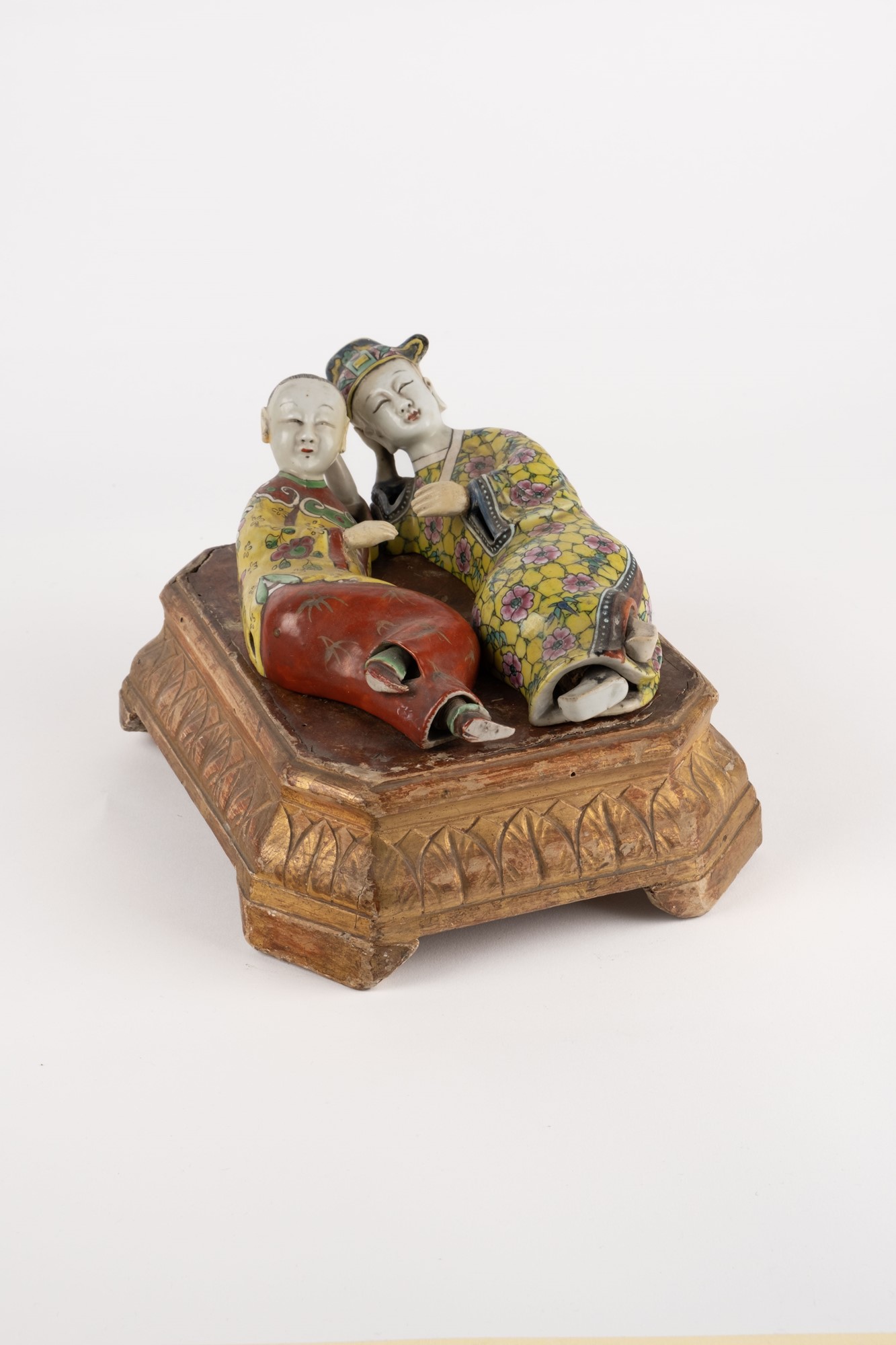 Two reclining porcelain figures. China, 19th c.