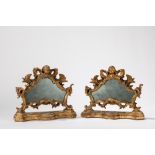 A pair of carved and gilt wood cartaglorias, mounted with mirrors