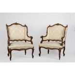 A pair of carved walnut armchairs