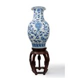 Oriental vase in white and blue porcelain with wooden base, 19th century