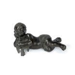 Bronze sculpture representing a putto lying down with a dove, 19th century