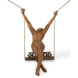 Wood sculpture representing a naked woman on a swing, 20th century