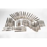Fifty-four knives and four forks from different services, 19th century