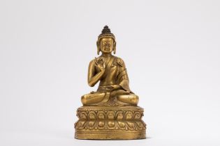 A GILT-BRONZE FIGURE OF A SEATED BUDDHA, Tibet, 18th century