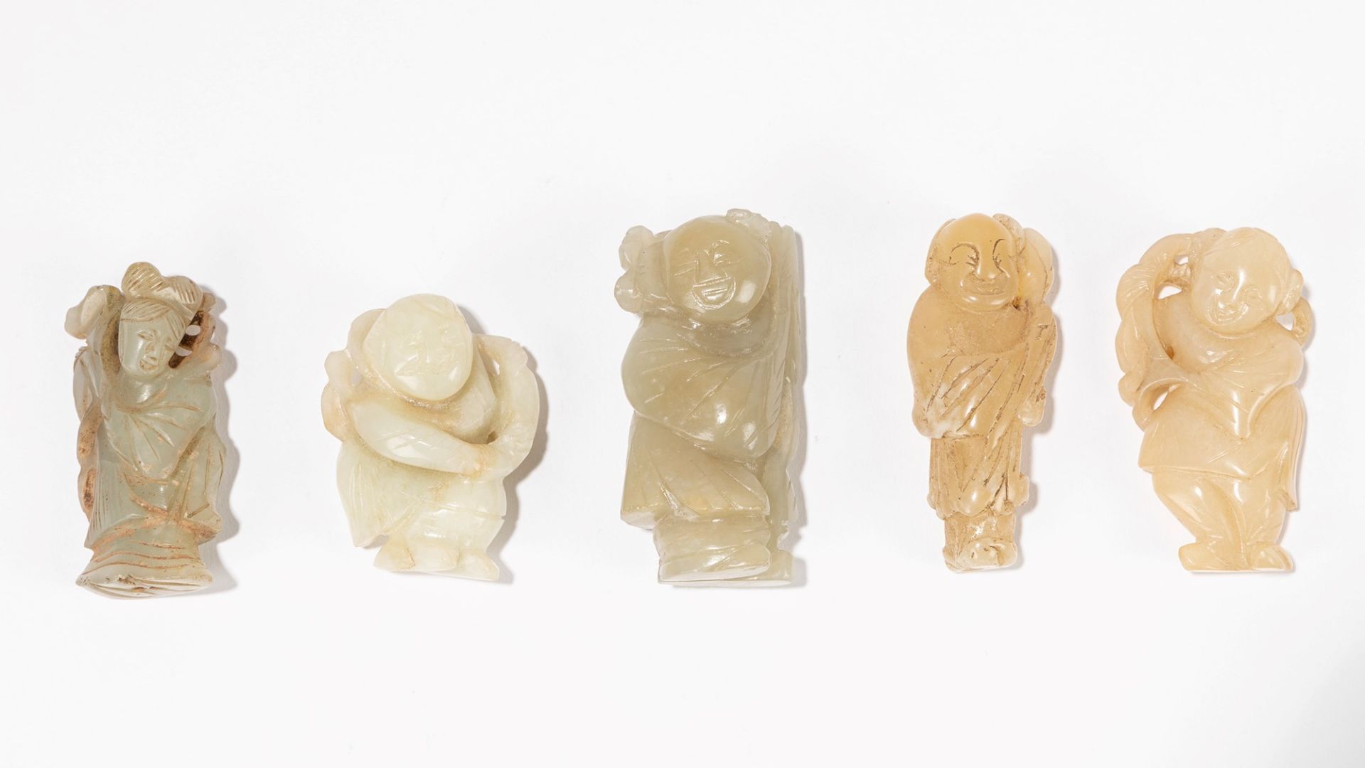 A GROUP OF FIVE CARVED JADE FIGURES, China, Qing dynasty, 19th / 20th century