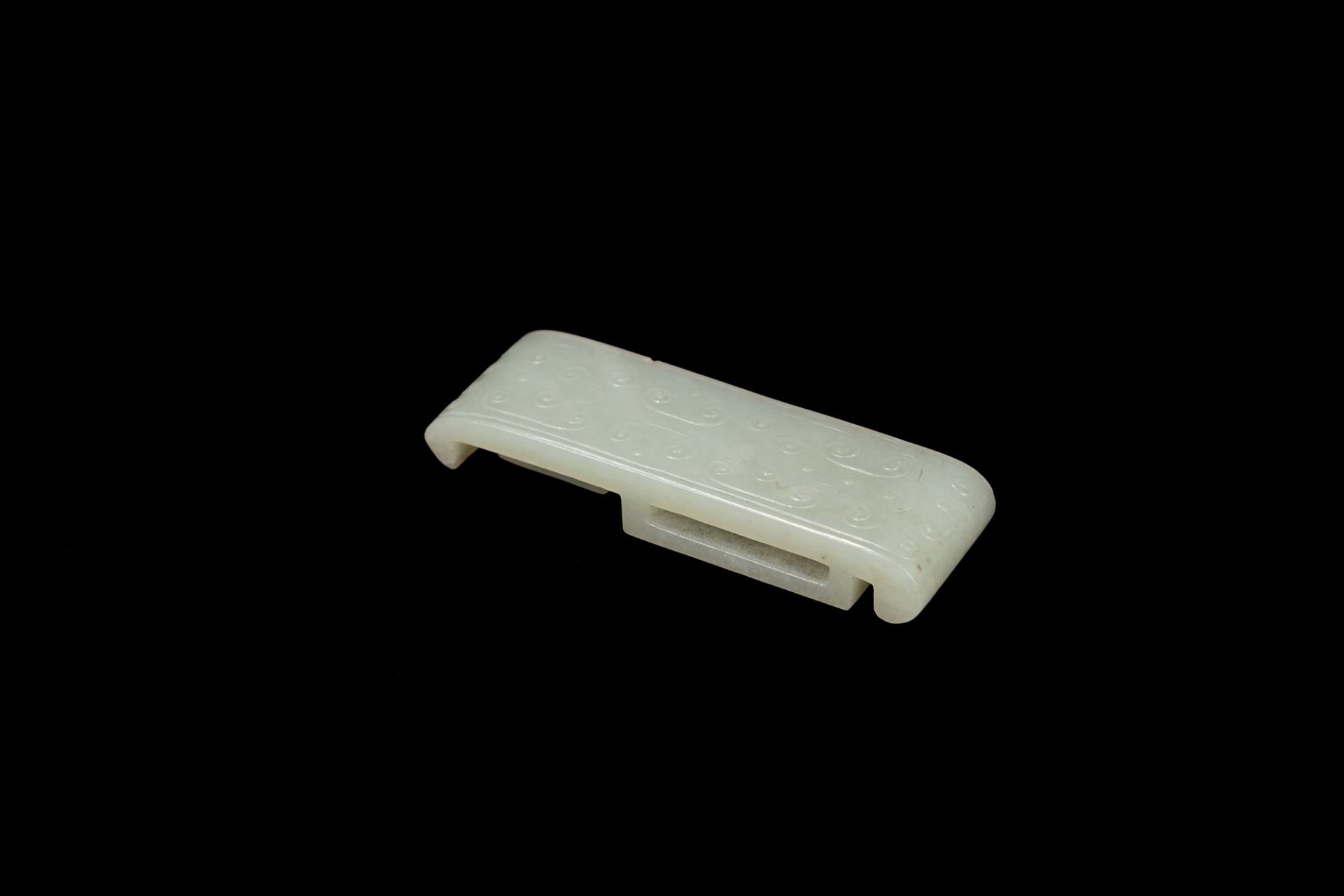 A WHITE JADE SWORD SLIDE, China, Qing dynasty, 19th century